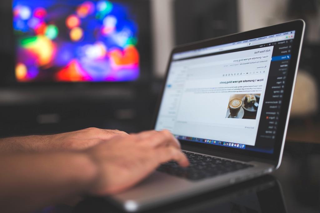 Hands typing on a sleek keyboard with modern web graphics and communication icons floating above