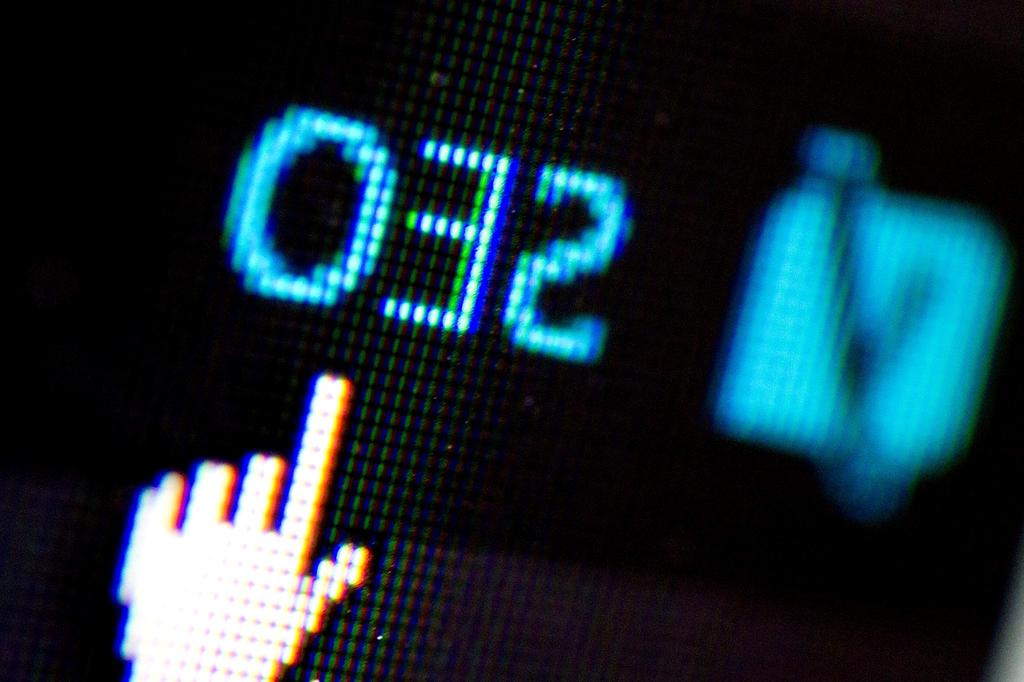 Close-up view of hands using a laptop with search results on screen